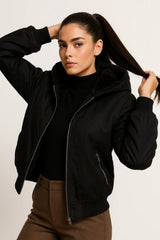 Black puffer jacket with hood and faux shearling lining, cozy winter outerwear for women.