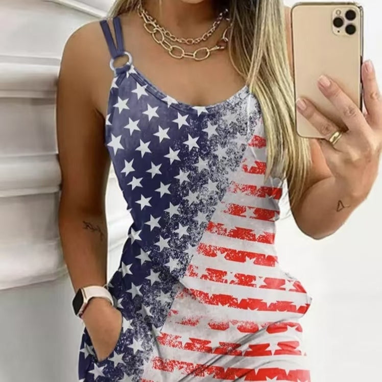 Woman wearing a sleeveless dress with distressed American flag print, taking a mirror selfie with stars on one side and red stripes on the other.