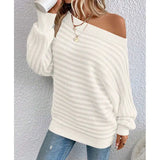 woman wearing a pink off-shoulder ribbed sweater styled with denim for a casual chic look